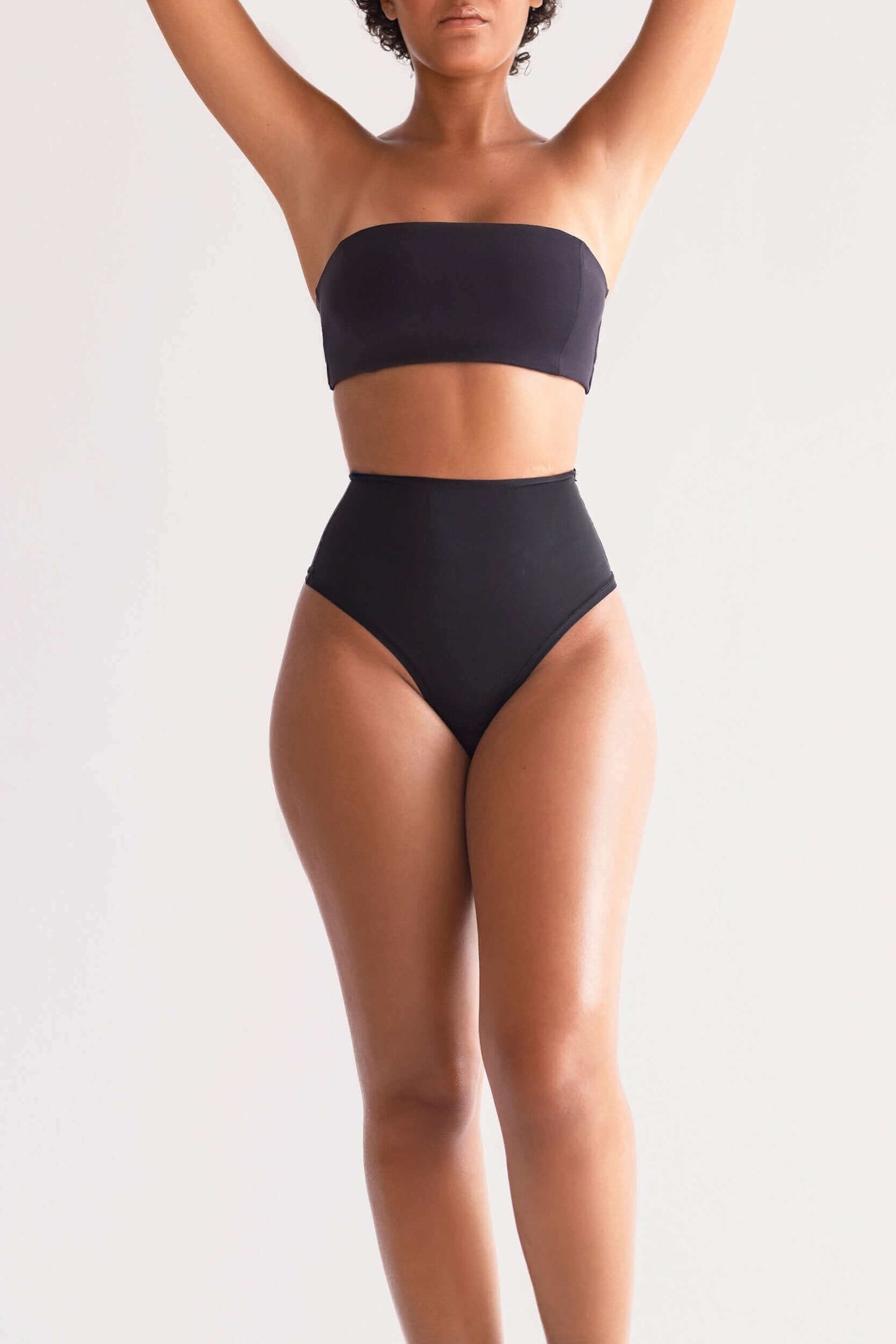 Model wearing UNDRESSE High-Waist Thong in Black Front Side